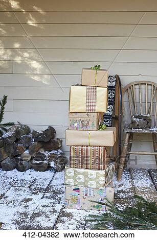Stack of Christmas gifts on snowy patio View Large Photo Image Stock Image - Stack of Christmas gifts on snowy patio. Fotosearch