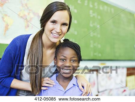Student and teacher smiling in class View Large Photo Image Stock Photography - Student and teacher smiling in class. Fotosearch
