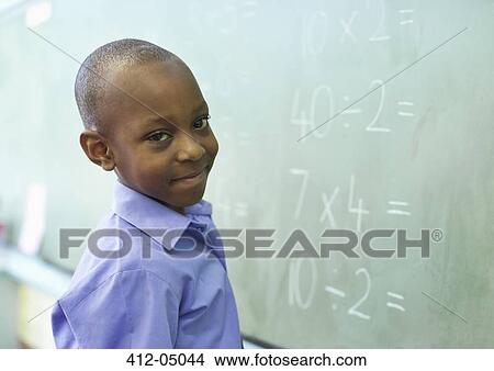 Student at chalkboard in class View Large Photo Image Picture - Student at chalkboard in class. Fotosearch
