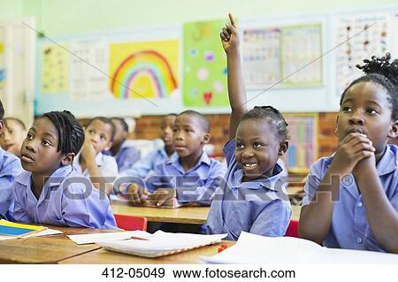 Stock Photo - Student raising hand in class. Fotosearch
