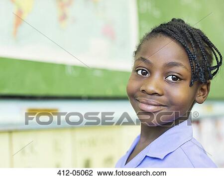 Stock Image - Student smiling in class. Fotosearch