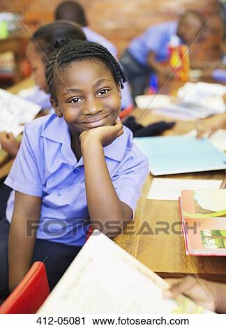 Stock Image - Student smiling in class. Fotosearch