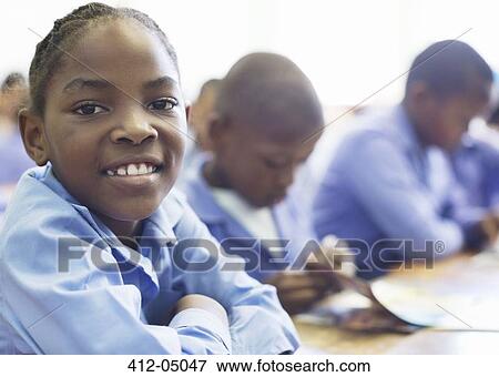 Student smiling in class View Large Photo Image Stock Photo - Student smiling in class. Fotosearch