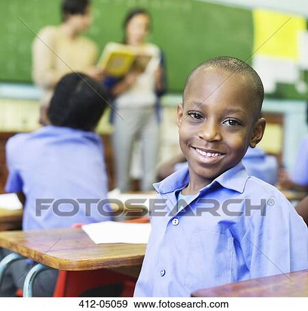 Stock Photo - Student smiling in class. Fotosearch
