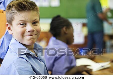 Stock Photograph - Student smiling in class. Fotosearch