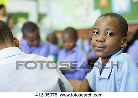 Stock Photograph - Student smiling in class. Fotosearch