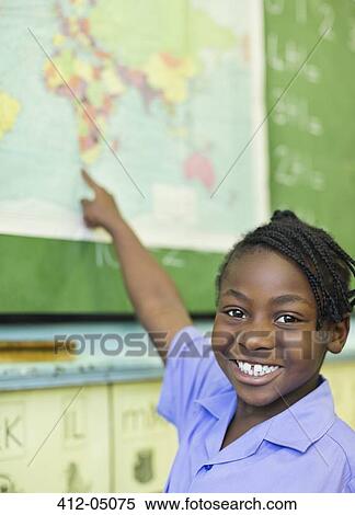 Stock Photography - Student using world map in class. Fotosearch