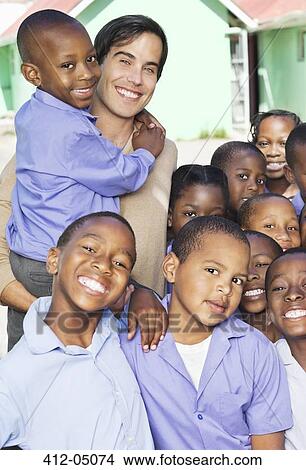 Students and teacher smiling outdoors View Large Photo Image Picture - Students and teacher smiling outdoors. Fotosearch