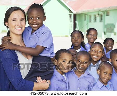 Stock Image - Students and teacher smiling outdoors. Fotosearch