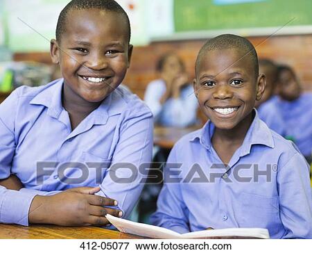 Stock Photo - Students smiling in class. Fotosearch