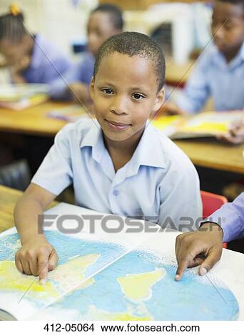 Picture - Students using world map in class. Fotosearch