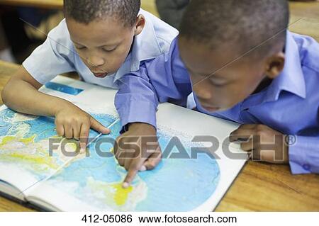 Stock Photograph - Students using world map in class. Fotosearch