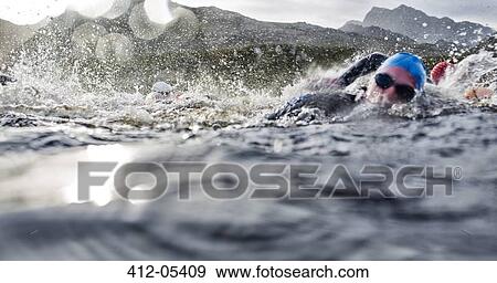 Swimmers splashing in water View Large Photo Image Stock Photo - Swimmers splashing in water. Fotosearch