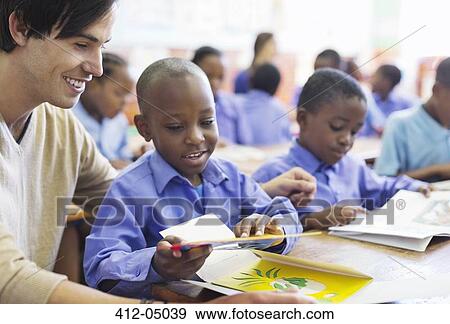 Teacher working with student in classroom View Large Photo Image Stock Photo - Teacher working with student in classroom. Fotosearch
