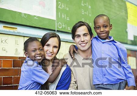 Stock Image - Teachers and students smiling in class. Fotosearch