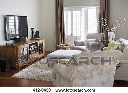 Stock Image - Television and armchairs in living room. Fotosearch