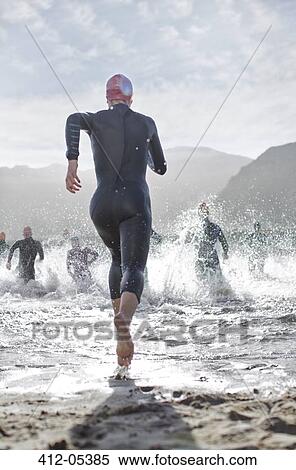 Stock Photography - Triathletes at start of swimming race. Fotosearch