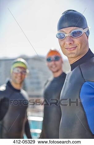 Triathletes wearing wetsuits outdoors View Large Photo Image Stock Photo - Triathletes wearing wetsuits outdoors. Fotosearch