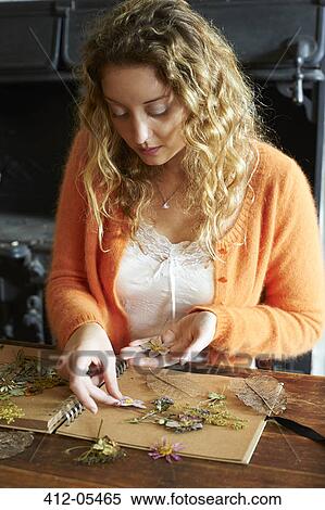 Woman arranging dried flowers on notebook View Large Photo Image Stock Photography - Woman arranging dried flowers on notebook. Fotosearch