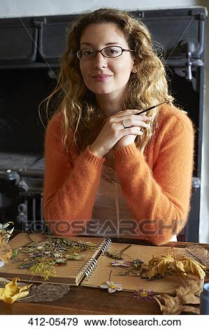 Stock Photo - Woman decorating dried herbs and flowers. Fotosearch