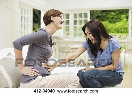 Woman holding pregnant friend's bell View Large Photo Image Stock Image - Woman holding pregnant friend's bell. Fotosearch