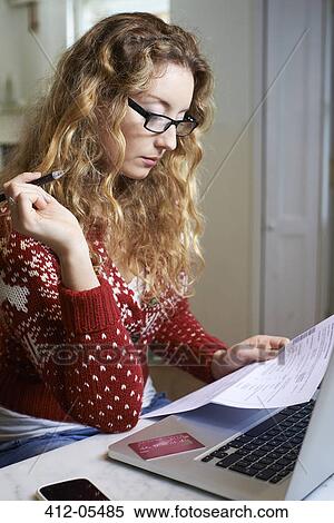 Woman paying bills on laptop View Large Photo Image Stock Photography - Woman paying bills on laptop. Fotosearch