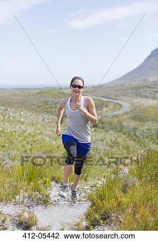 Woman running on dirt path View Large Photo Image Stock Image - Woman running on dirt path. Fotosearch