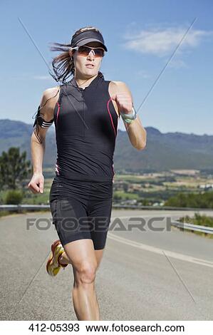 Woman running on rural road View Large Photo Image Stock Image - Woman running on rural road. Fotosearch