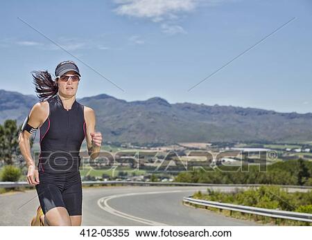 Woman running on rural road View Large Photo Image Stock Photography - Woman running on rural road. Fotosearch