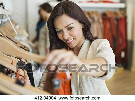 Woman shopping in clothes store View Large Photo Image Picture - Woman shopping in clothes store. Fotosearch