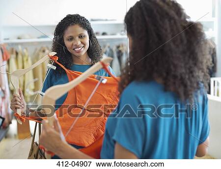 Woman shopping in clothes store View Large Photo Image Stock Photo - Woman shopping in clothes store. Fotosearch