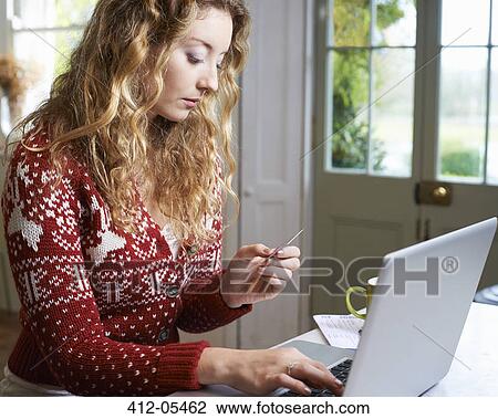 Woman shopping on laptop View Large Photo Image Stock Image - Woman shopping on laptop. Fotosearch