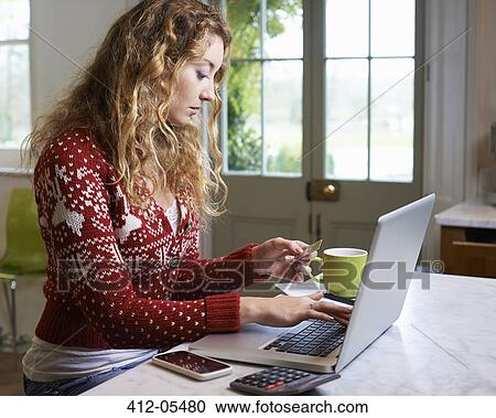 Woman shopping on laptop View Large Photo Image Stock Image - Woman shopping on laptop. Fotosearch