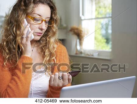 Woman shopping on telephone View Large Photo Image Stock Photo - Woman shopping on telephone. Fotosearch
