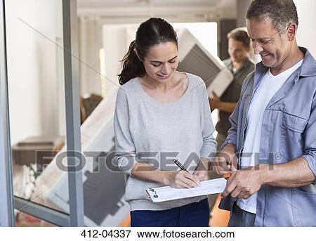Woman signing for package View Large Photo Image Stock Photo - Woman signing for package. Fotosearch