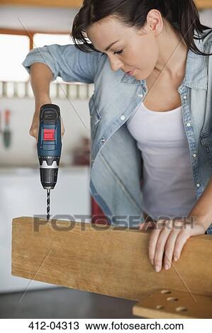 Stock Image - Woman working in workshop. Fotosearch