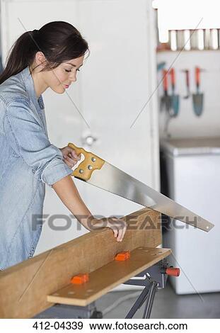 Stock Photo - Woman working in workshop. Fotosearch
