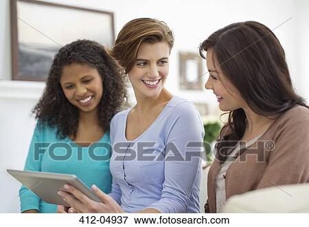 Women using tablet computer together View Large Photo Image Stock Photo - Women using tablet computer together. Fotosearch