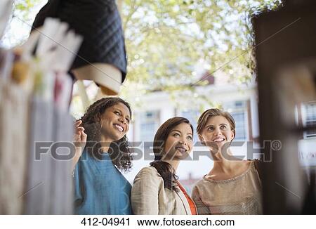 Women window shopping on city street View Large Photo Image Stock Image - Women window shopping on city street. Fotosearch