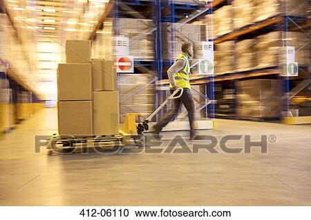 Blurred view of worker carting boxes in warehouse View Large Photo Image Stock Image - Blurred view of worker carting boxes in warehouse. Fotosearch