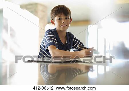 Boy doing homework at counter View Large Photo Image Stock Image - Boy doing homework at counter. Fotosearch
