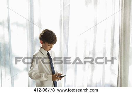 Boy in shirt and tie using cell phone View Large Photo Image Stock Photo - Boy in shirt and tie using cell phone. Fotosearch