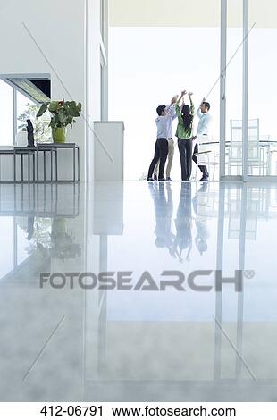 Stock Image - Business people cheering in office. Fotosearch