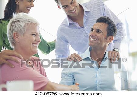 Stock Photograph - Business people laughing in meeting. Fotosearch