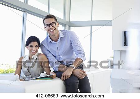 Business people smiling in office View Large Photo Image Stock Photo - Business people smiling in office. Fotosearch