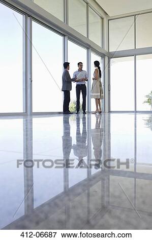 Business people talking in office View Large Photo Image Stock Photo - Business people talking in office. Fotosearch