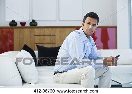 Businessman sitting on sofa View Large Photo Image Stock Image - Businessman sitting on sofa. Fotosearch