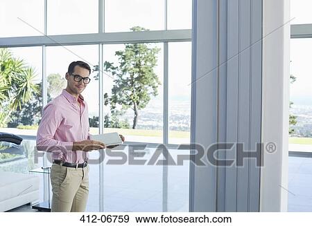 Businessman using tablet computer in office View Large Photo Image Stock Photo - Businessman using tablet computer in office. Fotosearch