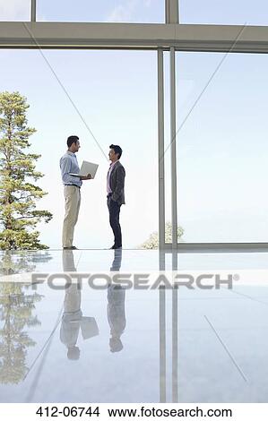 Businessmen talking in office View Large Photo Image Picture - Businessmen talking in office. Fotosearch