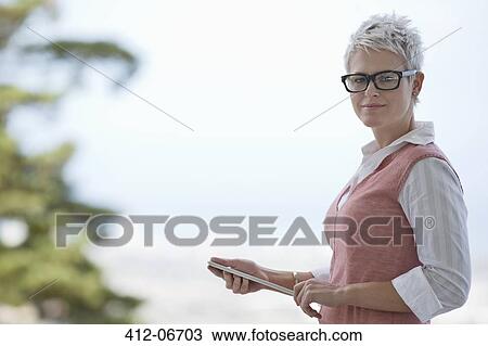 Businesswoman holding tablet computer View Large Photo Image Stock Image - Businesswoman holding tablet computer. Fotosearch